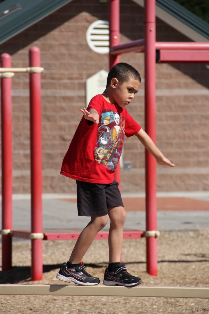 Little boy on balance beam